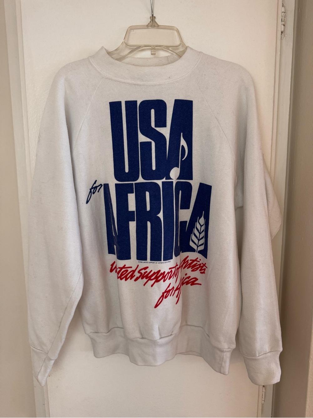 Vintage White Crewneck Sweatshirt with Bold Blue and Red USA for Africa Graphic